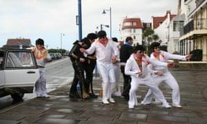 Anyplace is paradise: Elvis lookalikes get ready to roll in the town of Porthcawl, Wales.