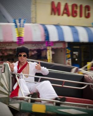 Another Elvis goes for a spin on a fairground ride on the seafront. The festival was originally started to support Porthcawl's Grand Pavilion.